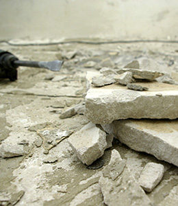 Concrete drill lying beside broken concrete