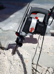 A heavy-duty drill boring into concrete