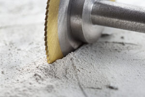 Saw cutting through a concrete slab